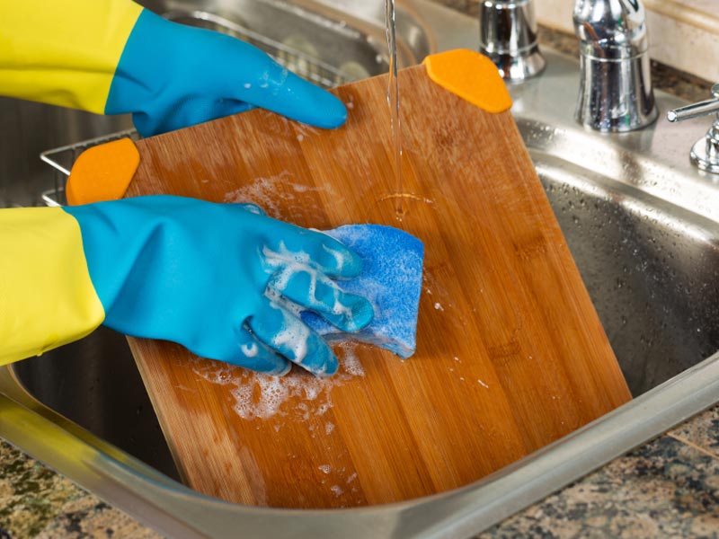 Use dish soap to clean wooden cutting board