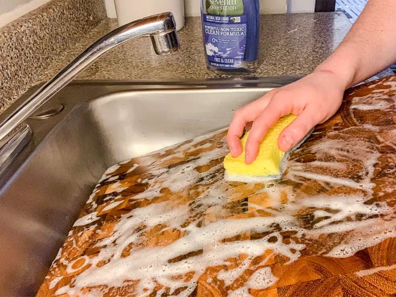Using dish soap to clean wooden cutting board